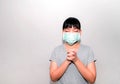 Portrait of an Asian girl wearing a coronavirus mask praying for the coronavirus to heal quickly on a white background