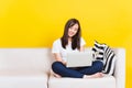 Young woman work from home she sitting on sofa using laptop computer in house Royalty Free Stock Photo