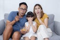Asian Happy Family Watch Excited Movie on Sofa