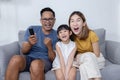 Asian Happy Family Watch Funny Movie on Sofa