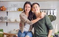 Portrait Asian happy young adult couple lover helping together, cooking in cozy home kitchen in morning, preparing breakfast meal Royalty Free Stock Photo