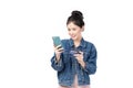 Portrait Asian happy young girl in jeans shirt smiling cheerful and showing plastic credit card while holding mobile phone Royalty Free Stock Photo