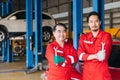 Portrait Asian Japanese male mechanic workers team in auto service workshop car maintenance center replace fix auto engine part Royalty Free Stock Photo