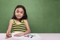 Portrait of asian kid drawing with colorful crayon