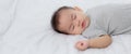 Portrait of asian little baby girl sleeping on bed in the bedroom at home, newborn napping with cozy and relax.