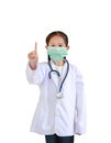 Portrait asian little child girl in doctor`s uniform with stethoscope and wearing medical mask showing one forefinger isolated on Royalty Free Stock Photo