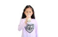 Portrait of asian little child girl drinking milk from glass bottle isolated on white background with looking at camera Royalty Free Stock Photo