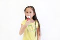 Portrait asian little child girl eating ice cream cone isolated on white background Royalty Free Stock Photo