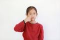 Portrait Asian little child with holding forefinger close his nose while smelling something intolerable smell  holding breath with Royalty Free Stock Photo