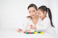 Portrait of asian little cute girl playing colorful blocks with her mother over white background. Royalty Free Stock Photo