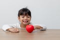 Portrait of Asian little girl child holding red heart sign on white background Royalty Free Stock Photo