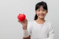 Portrait of Asian little girl child holding red heart sign on white background Royalty Free Stock Photo