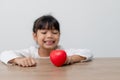 Portrait of Asian little girl child holding red heart sign on white background Royalty Free Stock Photo