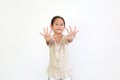 Portrait of asian little girl gesture hands spread her fingers over white background. Focus at kid face