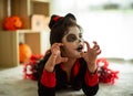 Portrait Asian little girl in Halloween costume acting scary and