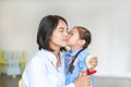 Portrait Asian little girl kissing her mom and hugging on Mother`s day in thailand. Royalty Free Stock Photo