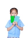 Portrait of Asian little girl in school uniform holding account book isolated on white background. Schoolgirl with bank passbook. Royalty Free Stock Photo