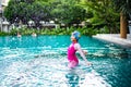 Portrait of Asian little girl swimming happily in the pool Royalty Free Stock Photo