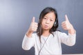 Portrait of asian little girl use headphone and smart phone Royalty Free Stock Photo