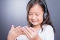 Portrait of asian little girl use headphone and smart phone Royalty Free Stock Photo