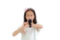 Portrait of Asian little girl using smart watch video camera against white background Royalty Free Stock Photo