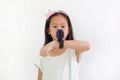 Portrait of Asian little girl using smart watch video camera against white background. Focus at smart watch at his hand Royalty Free Stock Photo