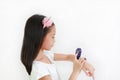 Portrait of Asian little girl using smart watch video camera against white background Royalty Free Stock Photo