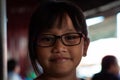 Portrait of an Asian little girl wearing glasses with sweet face