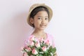 The child wears a hat and holding roses flowers with smiling and happy Royalty Free Stock Photo