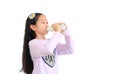 Portrait of asian little kid girl drinking milk from glass bottle isolated on white background with copy space Royalty Free Stock Photo