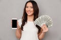 Portrait of asian lucky woman 20s holding fan of money dollar ba