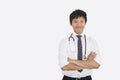 Portrait of Asian male doctor with arms crossed over white background Royalty Free Stock Photo