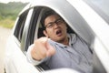 Angry Asian Male Driver, Screaming Pointing From His Car Royalty Free Stock Photo