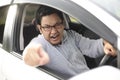 Angry Asian Male Driver, Screaming Pointing From His Car Royalty Free Stock Photo