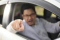 Angry Asian Male Driver, Screaming Pointing From His Car Royalty Free Stock Photo