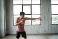 Asian male with dumbbell punching Royalty Free Stock Photo