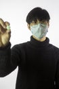 Portrait asian man in glasses, medical mask against covid-19 with pill in hand Royalty Free Stock Photo