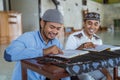 asian Man muslim reading quran together during ramadan at the mosque