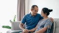Portrait of Asian mature couple sitting in the living room. wife and husband hugging, holding hand with happiness and cheerful. Royalty Free Stock Photo