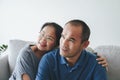 Portrait of Asian mature couple sitting in the living room. wife and husband hugging, holding hand with happiness and cheerful. Royalty Free Stock Photo