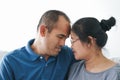 Portrait of Asian mature couple sitting in the living room. wife and husband hugging, holding hand with happiness and cheerful. Royalty Free Stock Photo