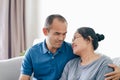 Portrait of Asian mature couple sitting in the living room. wife and husband hugging, holding hand with happiness and cheerful. Royalty Free Stock Photo