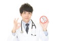 Doctor holds non smoking sign Royalty Free Stock Photo