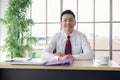 Portrait of Asian middle-aged businessman smiling and looking at the camera Royalty Free Stock Photo