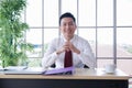 Portrait of Asian middle-aged businessman smiling and looking at the camera Royalty Free Stock Photo