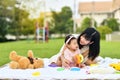 Asian mom and baby playing together in garden Royalty Free Stock Photo