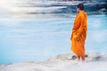 Portrait of asian monk looking at water river background with sunlight