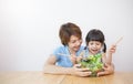 Portrait of asian mother and child daughter cooking salad healthy food together. Royalty Free Stock Photo