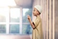 Portrait of asian muslim boy with white cap praying Royalty Free Stock Photo