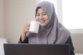Muslim Businesswoman Taking Coffee Break While Working in Home Royalty Free Stock Photo